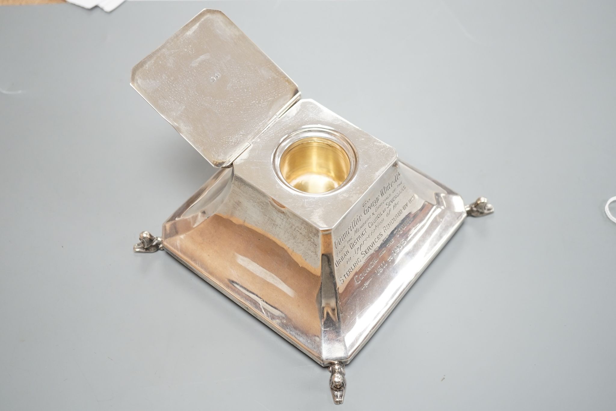 A George V silver mounted inkwell, Birmingham, 1924, with presentation inscription and monogram, 14.2cm.